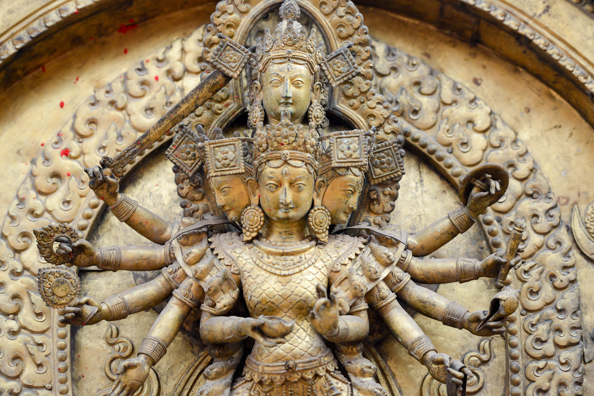 Devi Taleju Bhawani (with 10 arms standing on a lotus) adorns the Golden Gate in Bhaktapur Darbur Square, the main entrance to the Kumari temple. Built in 1753 by King Ranjit Malla.