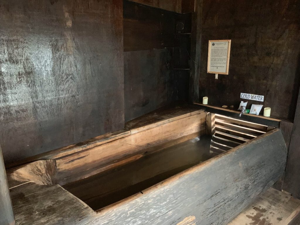 Bhutanese Hot Stone Bath. The bath tub is made of wood and constructed in the ground