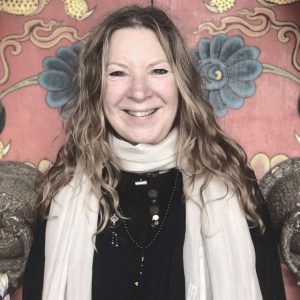 Portrait of Heather Elton infront of Neydo Monastery in Nepal.